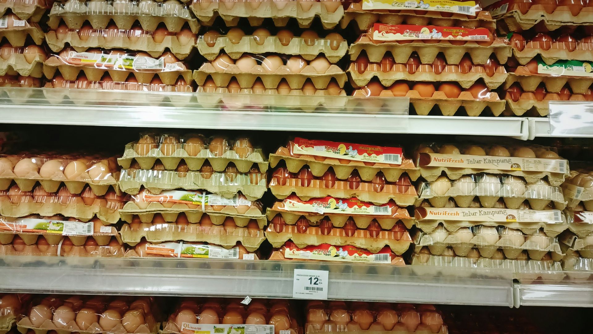 a display in a grocery store filled with lots of eggs
