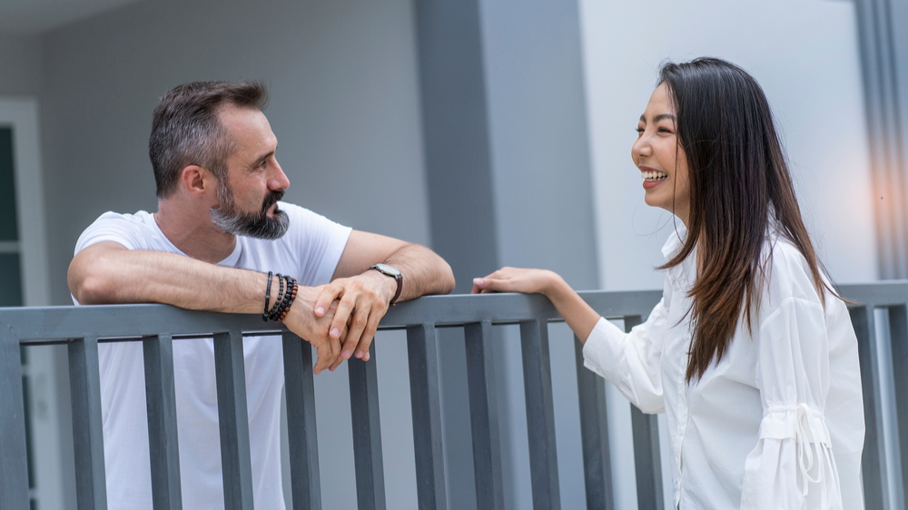 female neighbor walks to say hello to a male neighbor