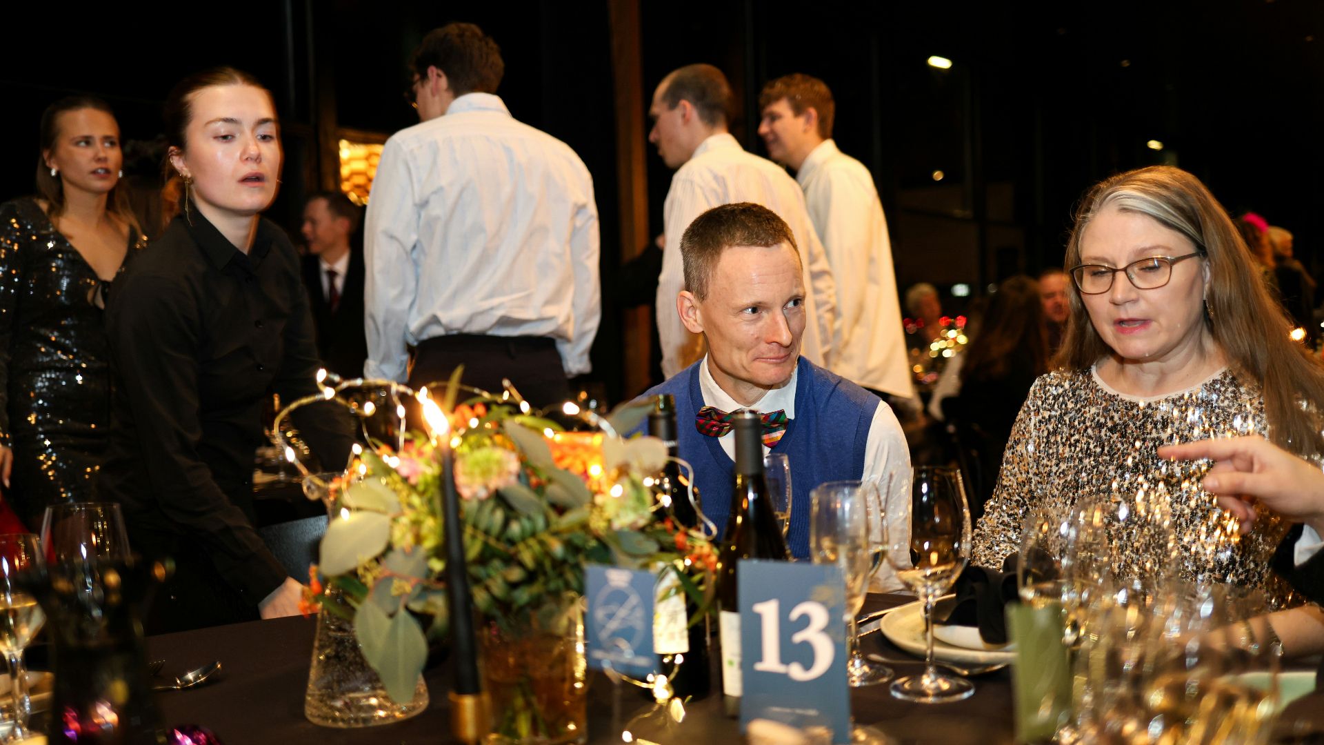 People gathered at a formal dinner event with decorations