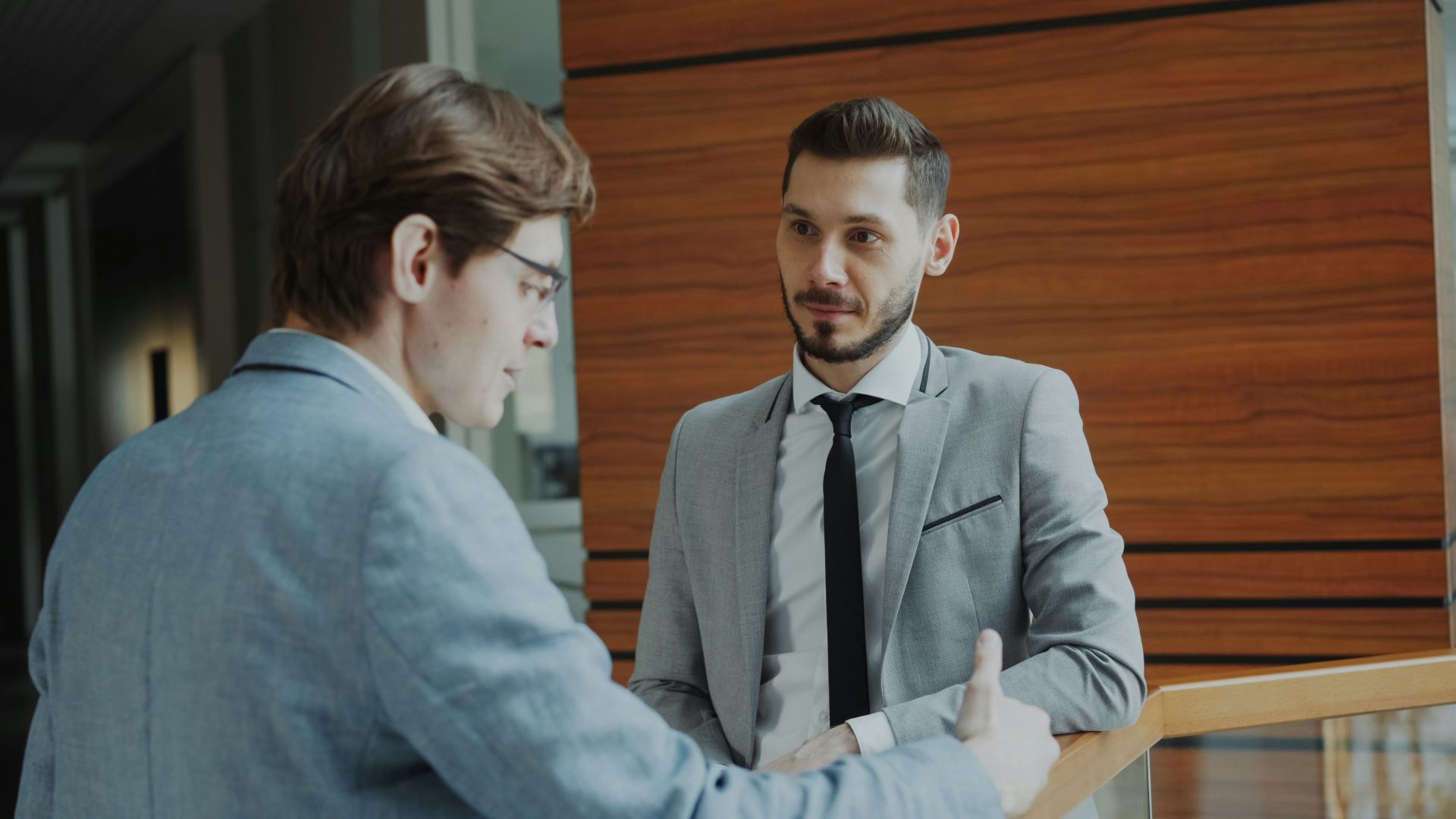 Two businessmen shaking hands in modern office