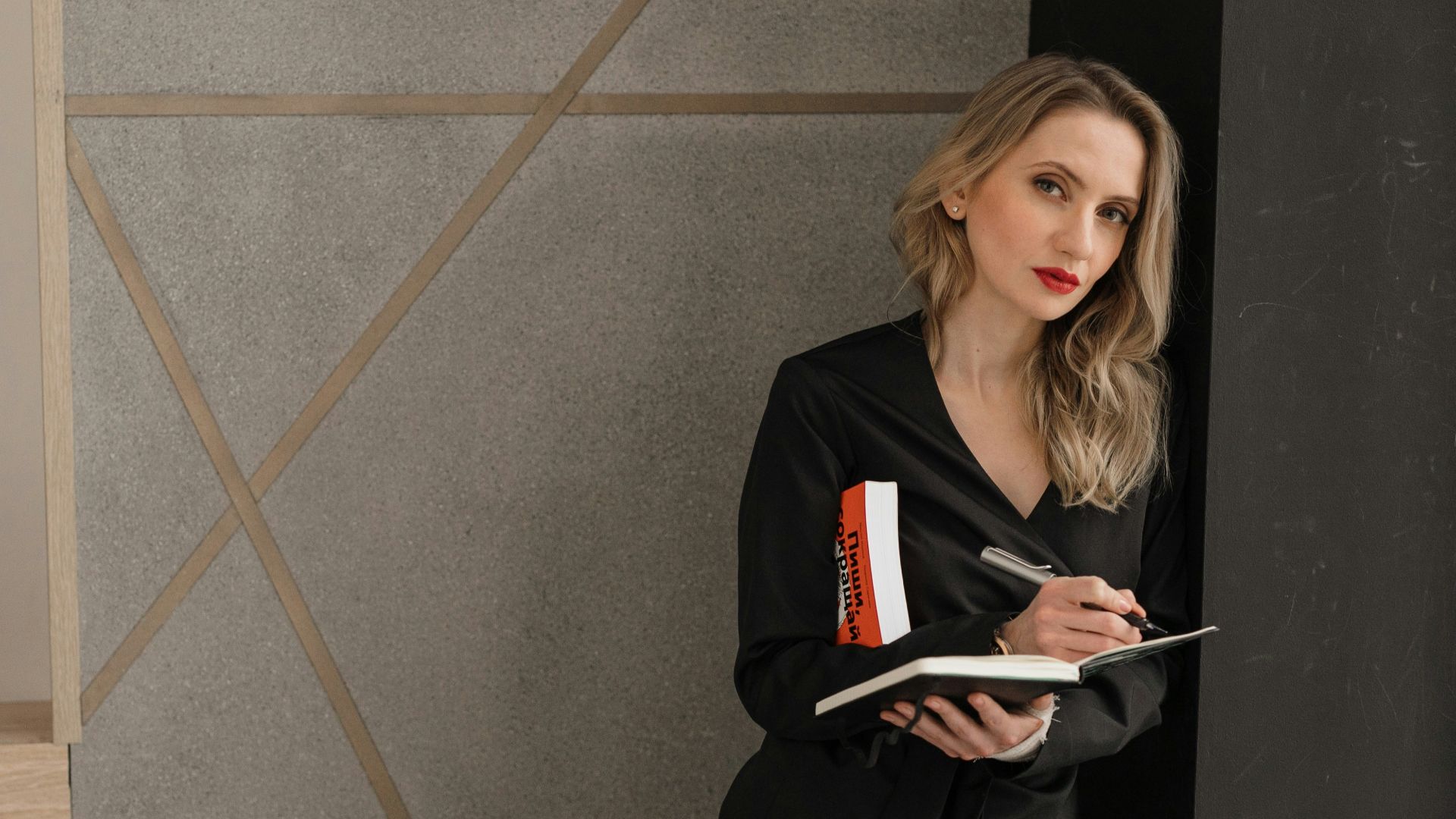woman in black long sleeve shirt holding book