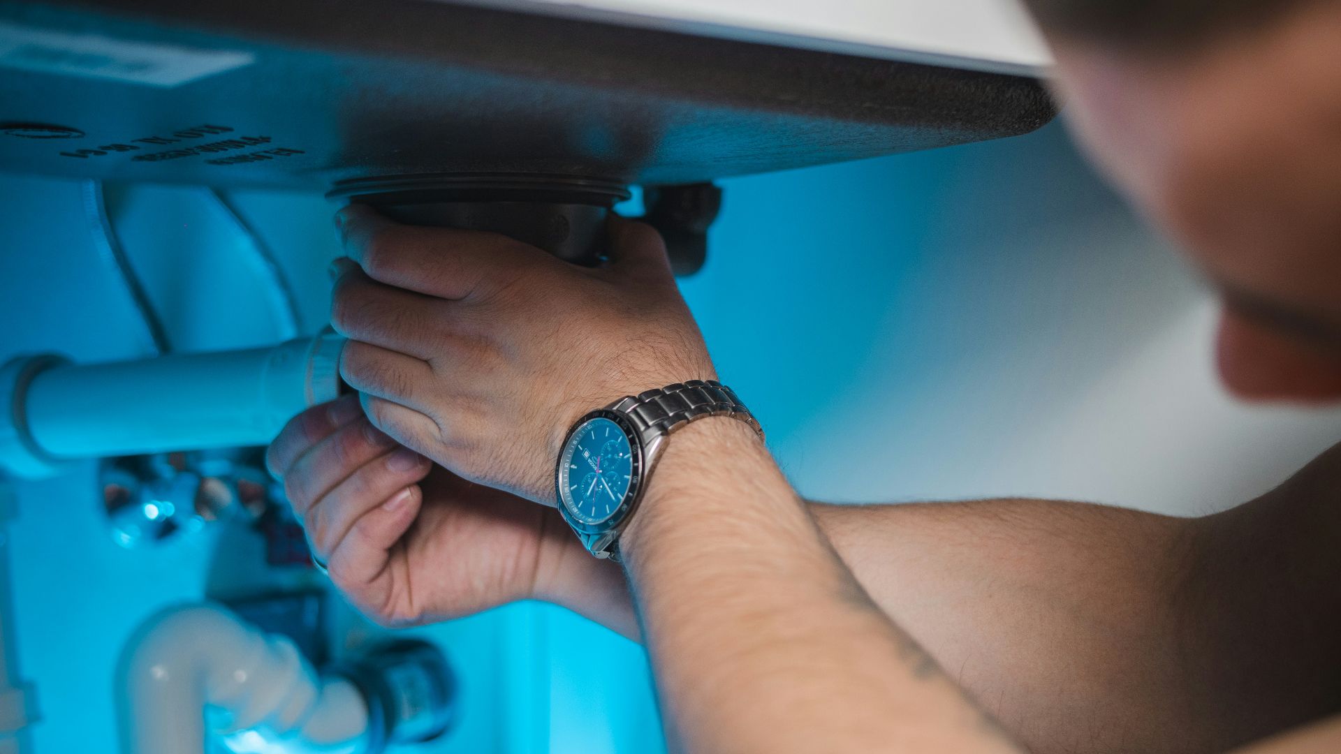 a man fixing a water heater in a room