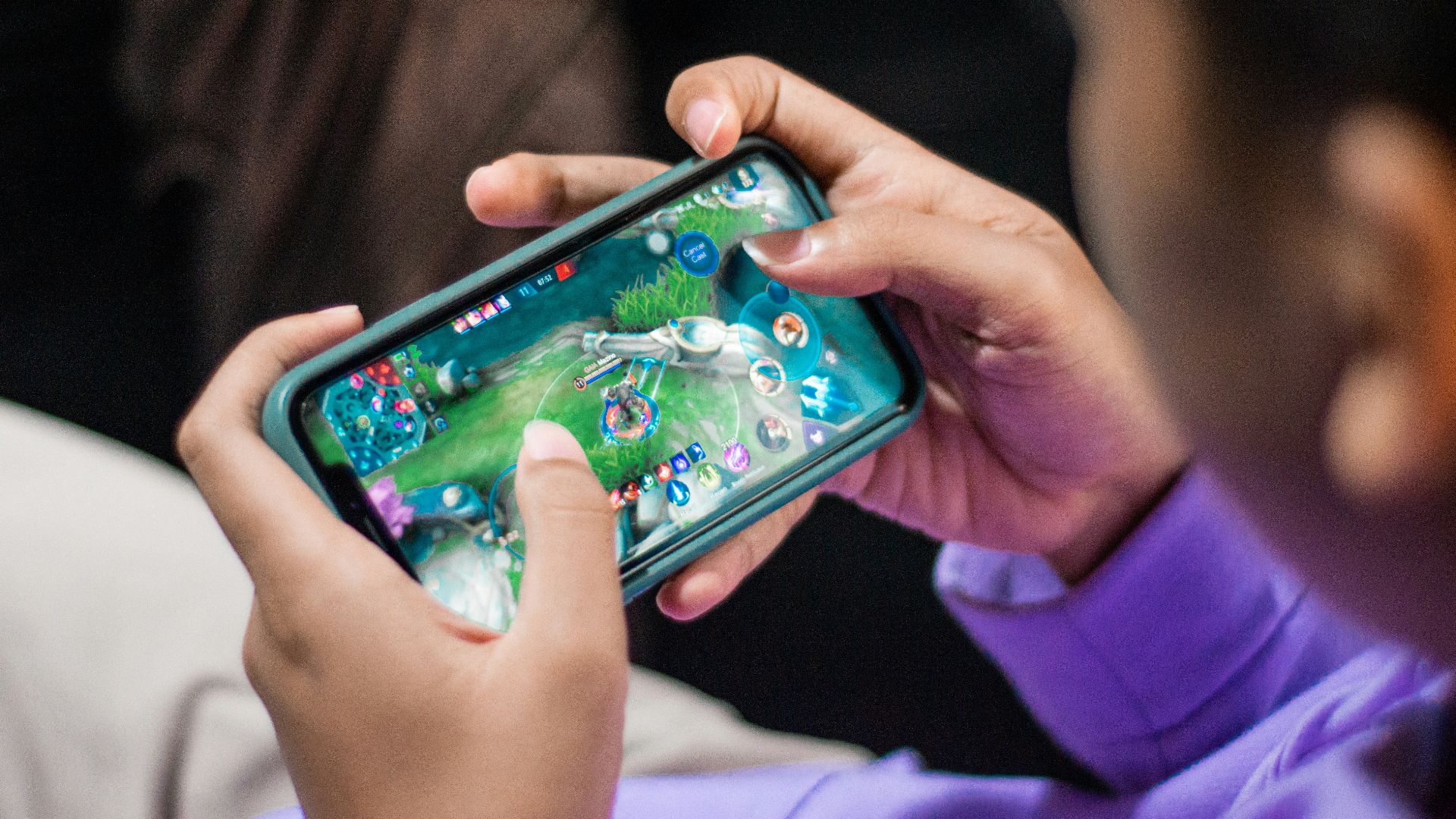 a person holding a cell phone in their hands