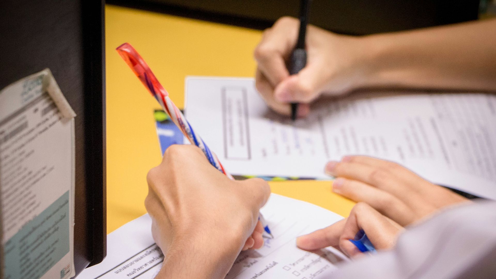 person writing on white paper