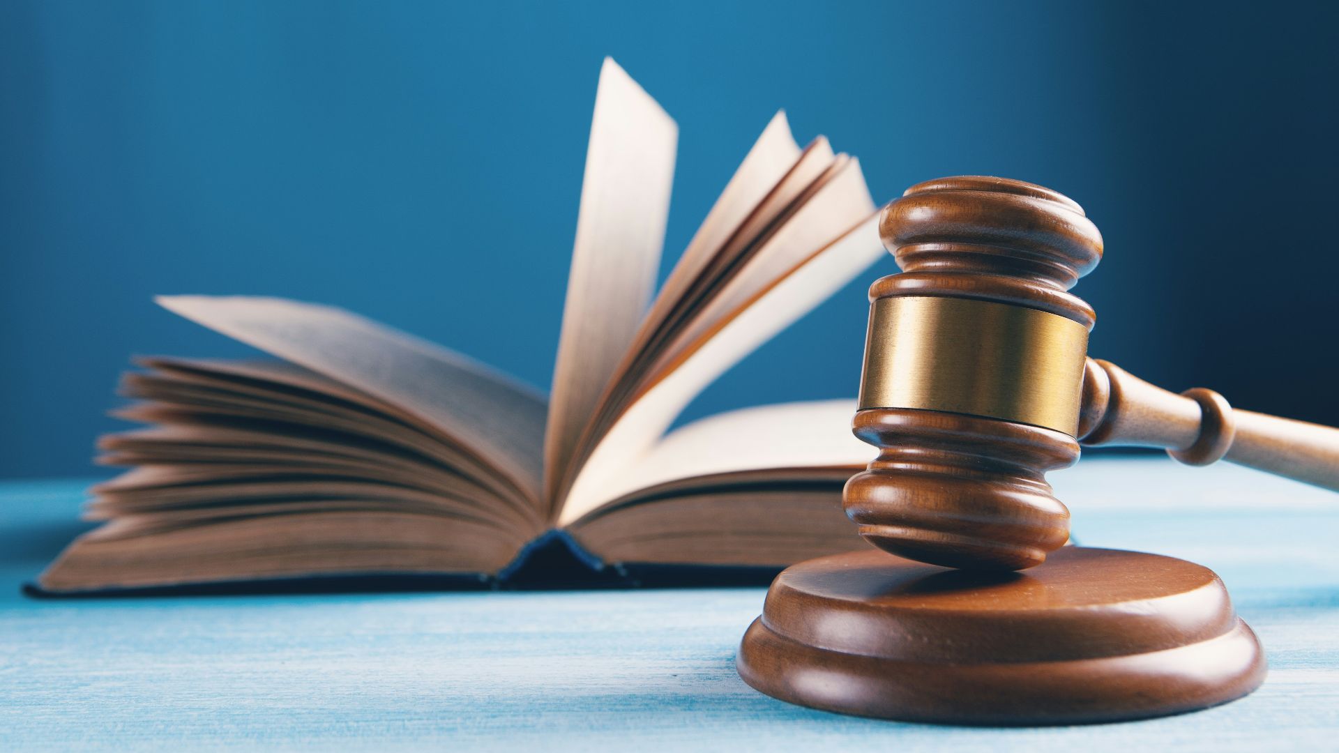 judges gavel and open book on table