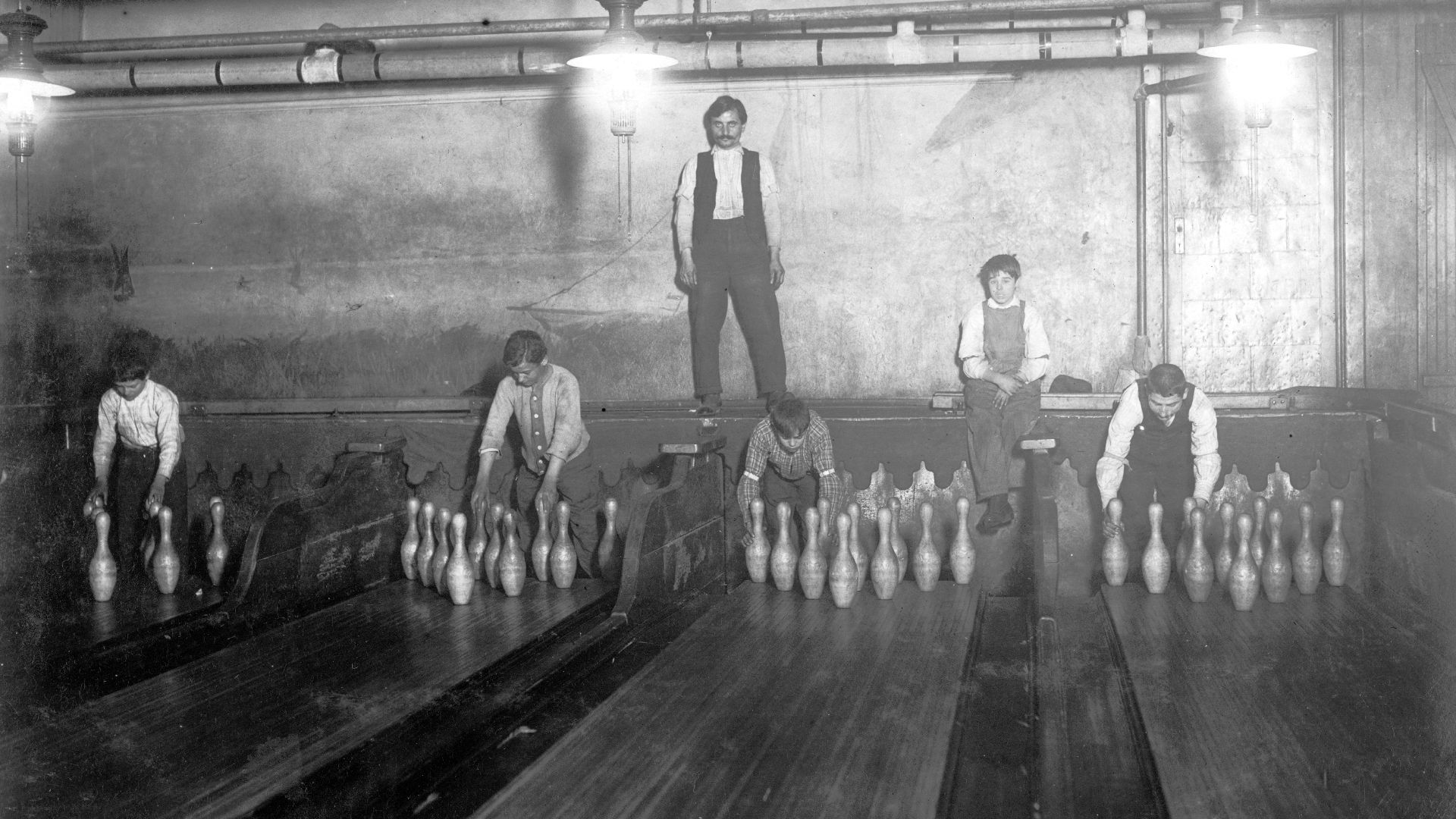 1:00 A.M. Pin boys working in Subway Bowling Alleys, 65 South St., B'klyn, N.Y. every night. 3 smaller boys were kept out of the photo by Boss. Location: New York--Brooklyn, New York (State).