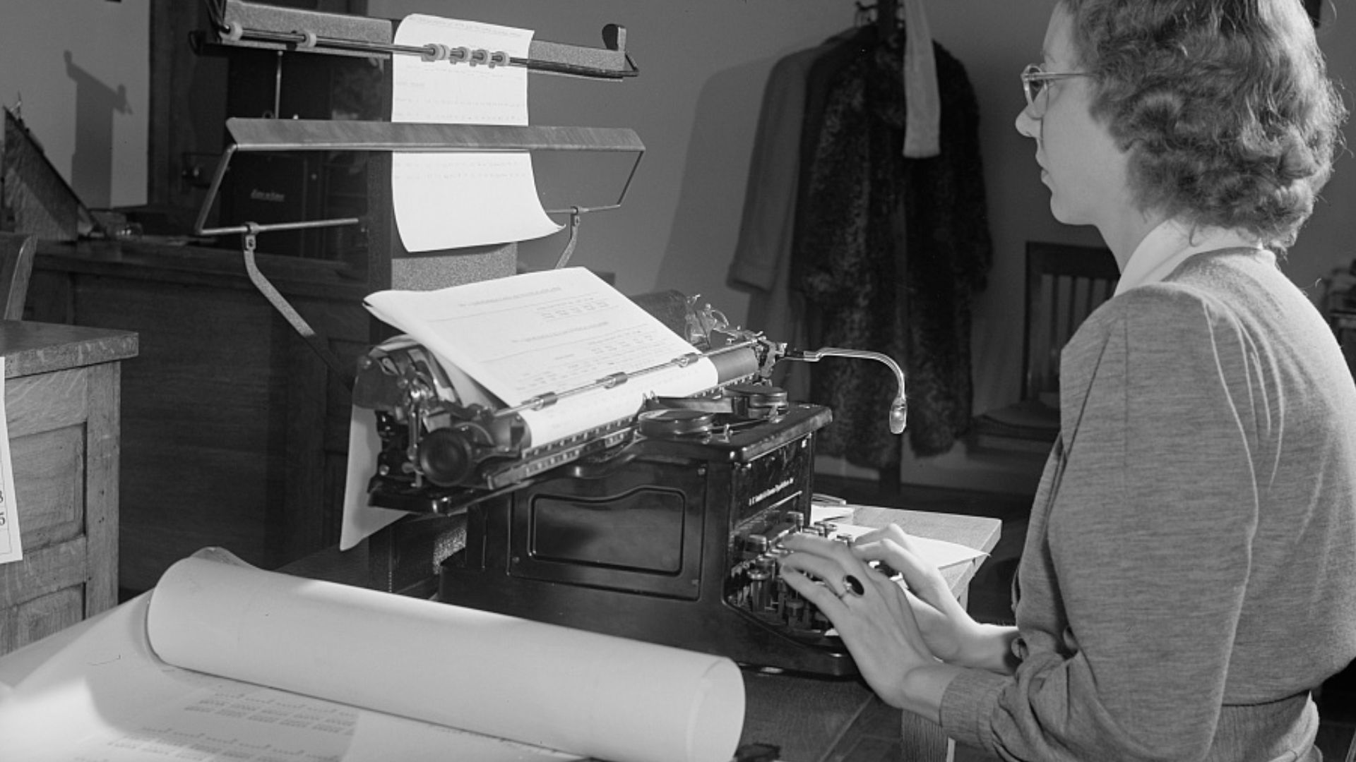 Female typist working on statistical tables.