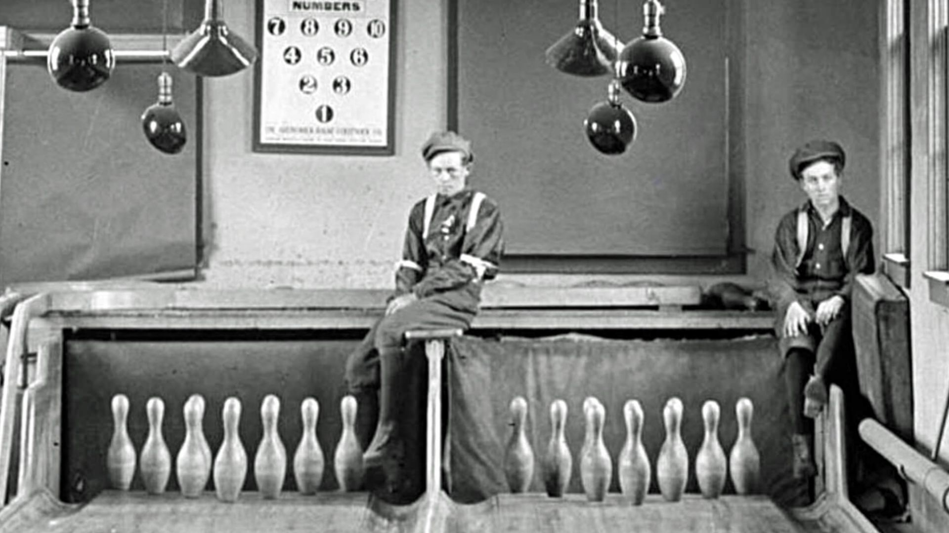 Two pinboys (human pinsetters)
Signs say: