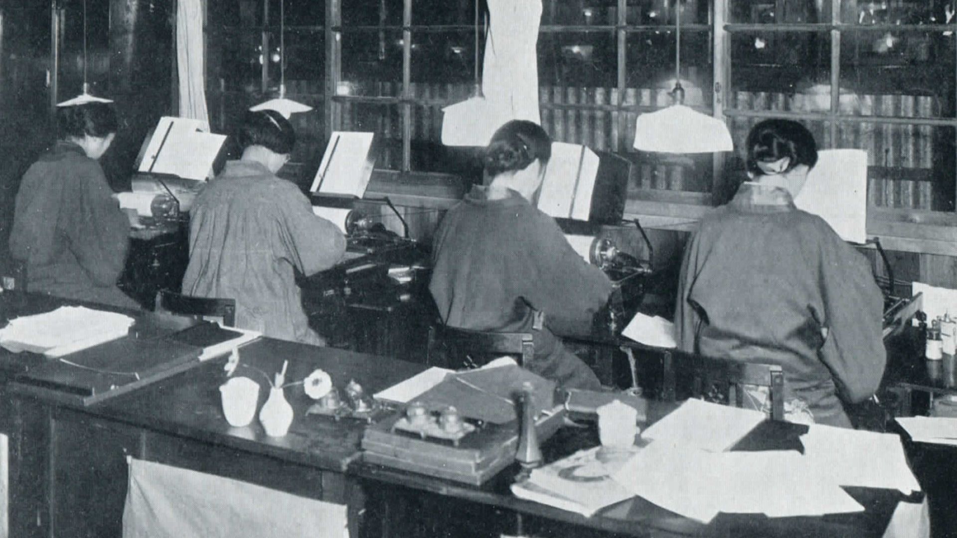 Original Caption: Typists. Machines adapted for Japanese script.