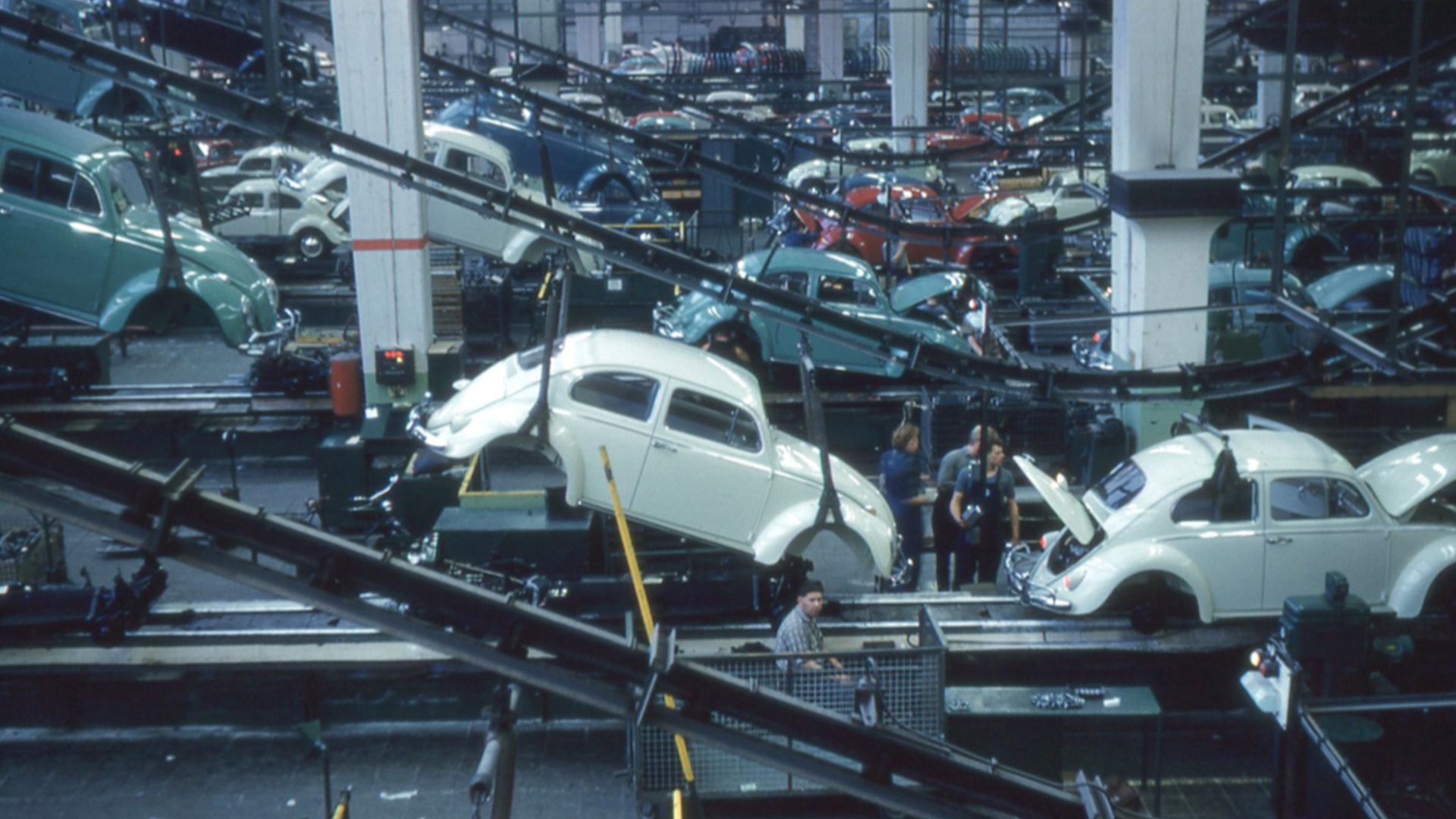Inside the Volkswagen plant. The bodies are dropped from an overhead line to be attached to the chassis.