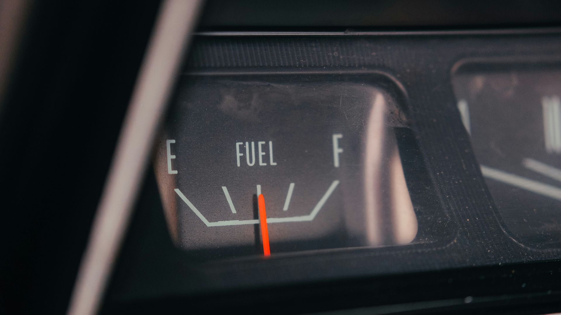 Close-up of a car's fuel gauge showing empty