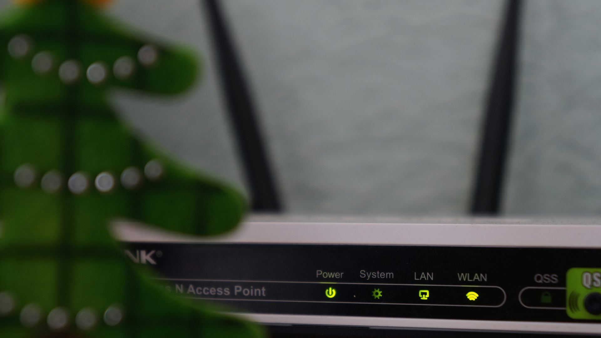 white and black modem router with four lights