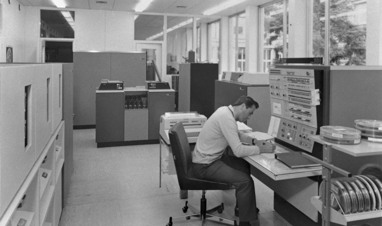 Bank clerk operating a teleprocessing machine