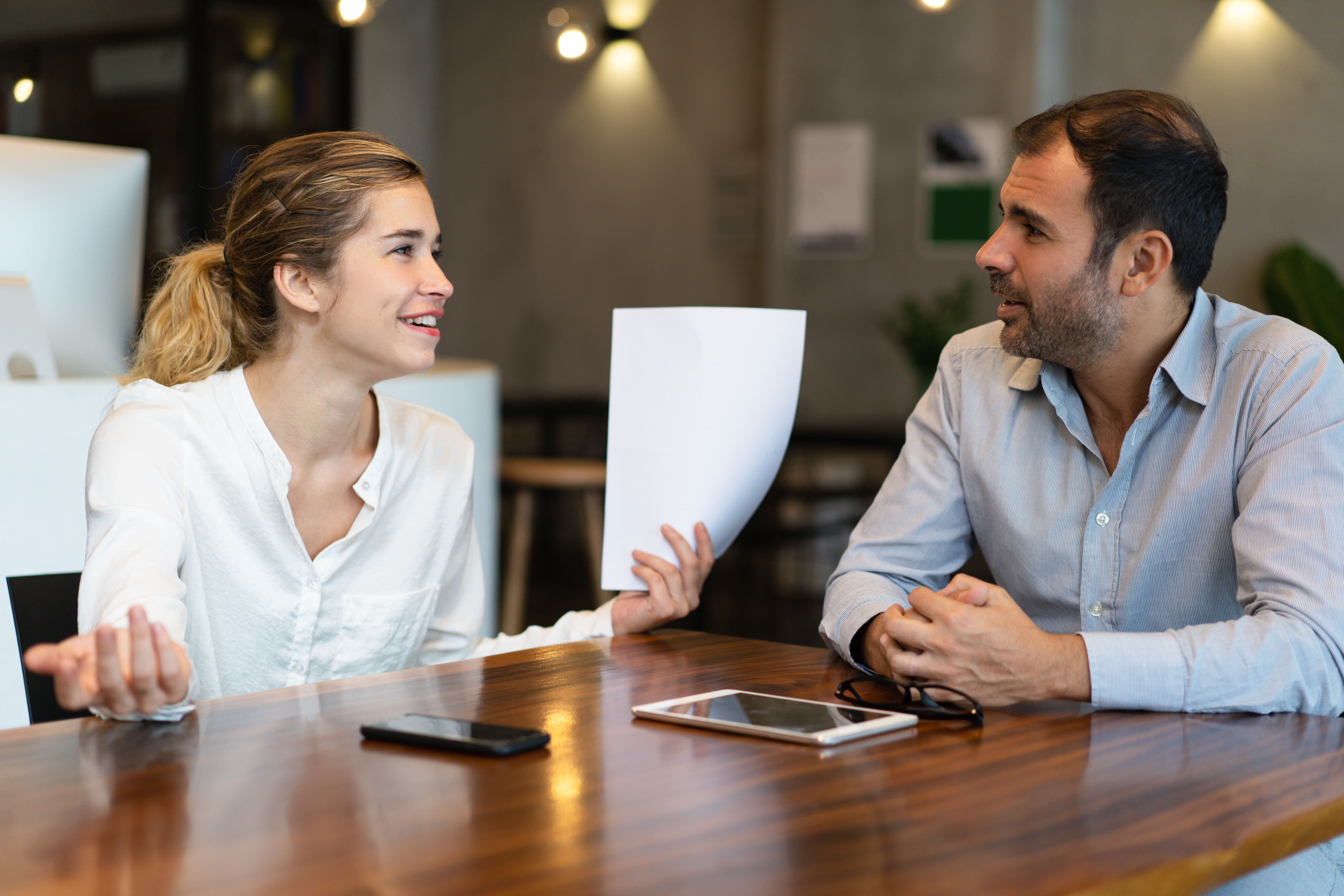 Woman and man talking with paperwork
