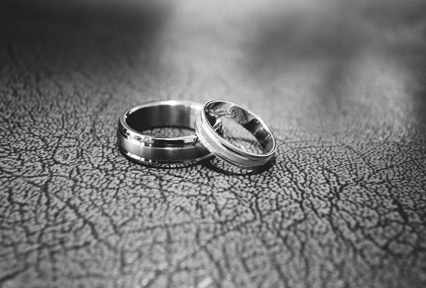 grayscale close up photo of wedding rings
