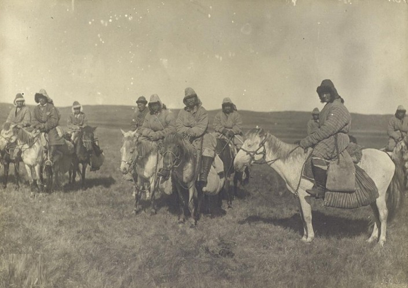 Kazakhs 19th Century standing outside on horses.