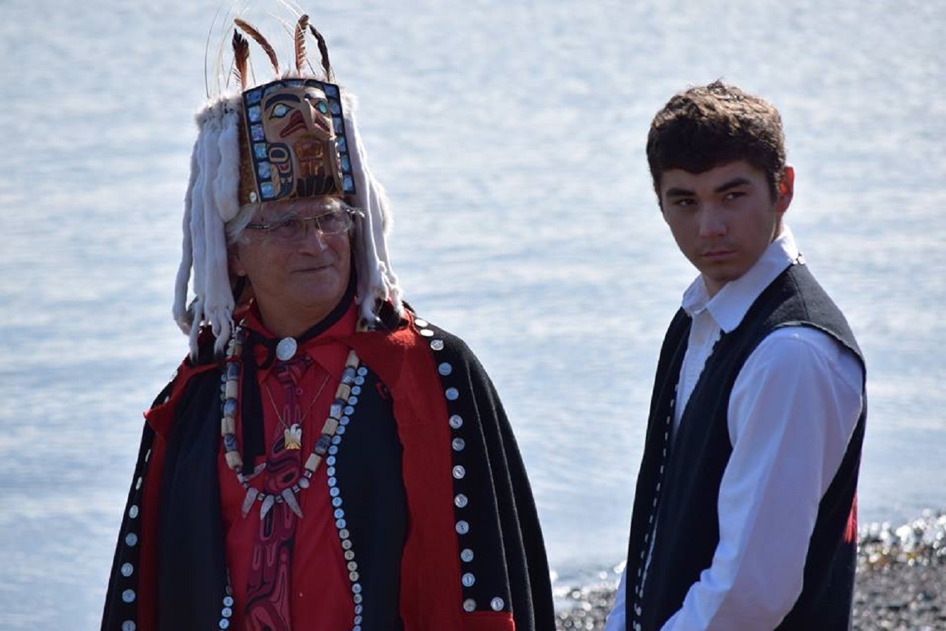 A Haida hereditary leader of the eagle moiety awaits guests with his nephew - 2016