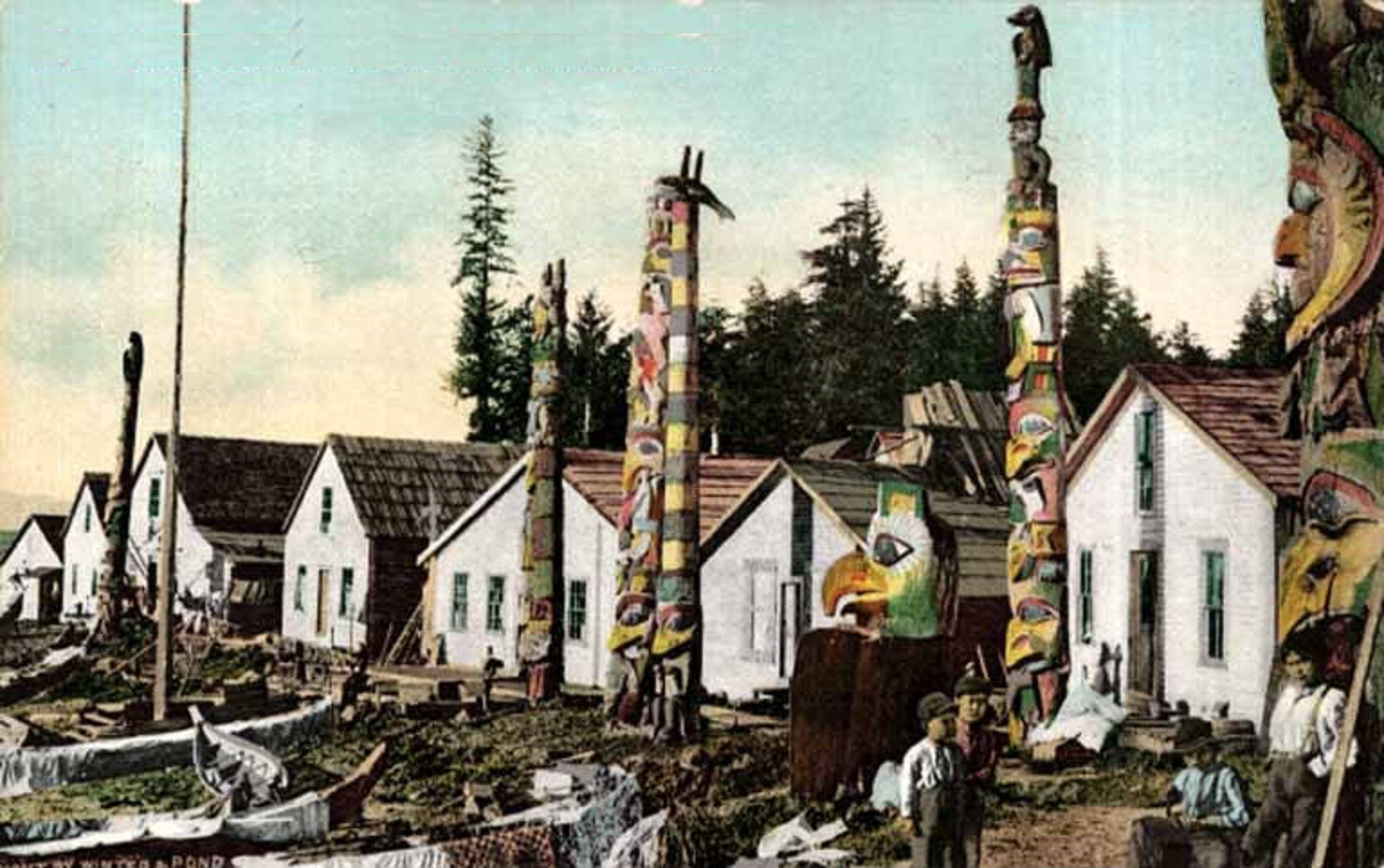 Haida boys near totem poles, canoes and houses at Howkan village, Long Island, Alaska, circa 1897