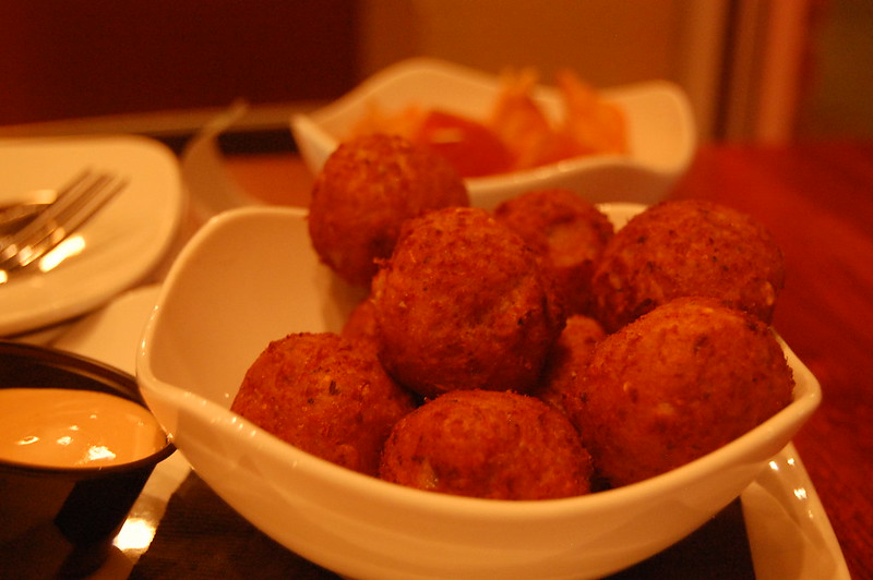 Close-up Photo of a white bowl with sauerkraut balls