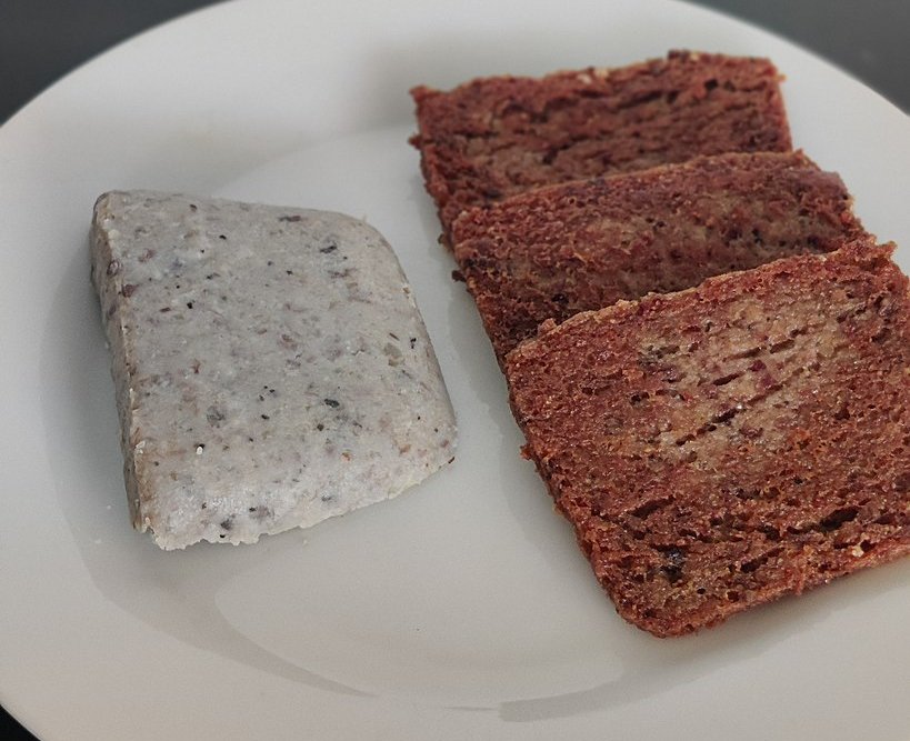 Close-up Image of cooked and uncooked scrapple on a white plate