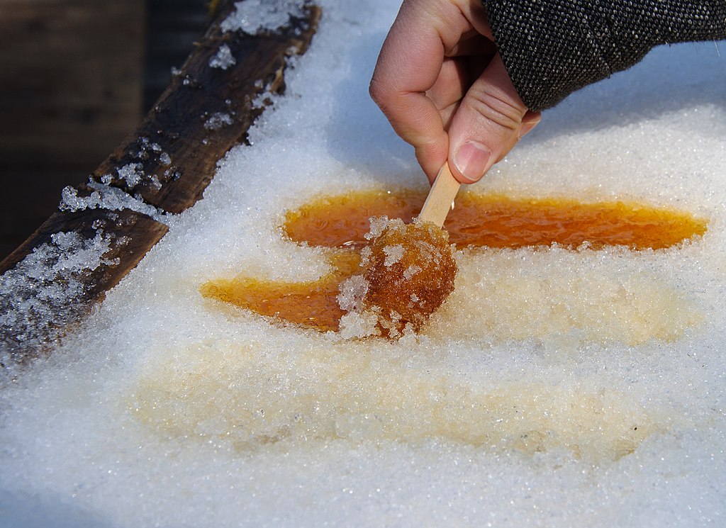 Close-up Photo of some persons hand holding Maple syrup popsicle