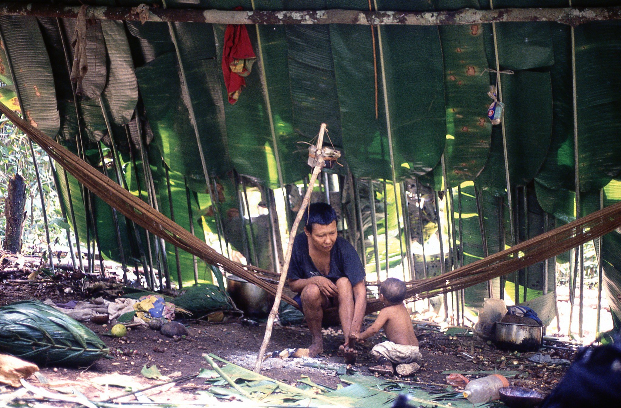 Nukak family under banana leaves