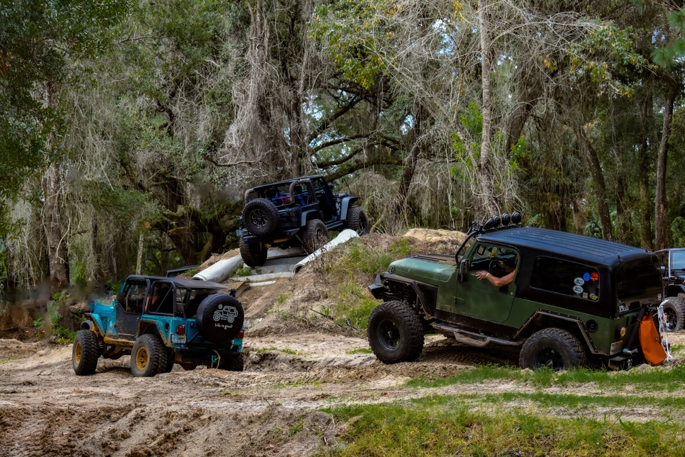 Several Jeeps slowly working their way through the Jeeptoberfest Offroad Adventure Course. - Ocala, Florida
