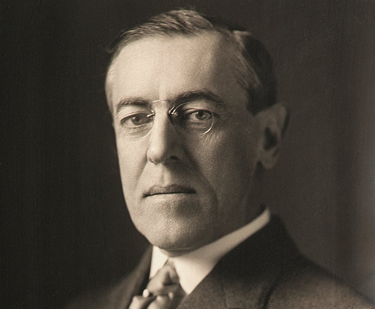 Grayscale Portrait Photo of President Woodrow Wilson in dark suit