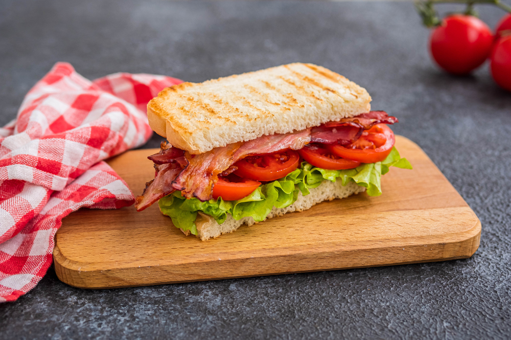 BLT sandwich on a wooden board