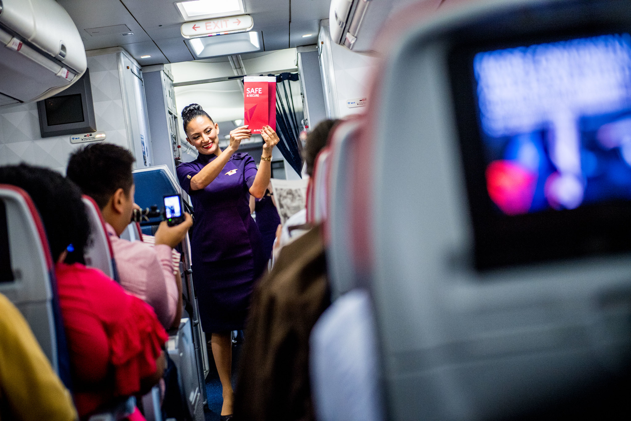 Flight attendant performing safety presentation