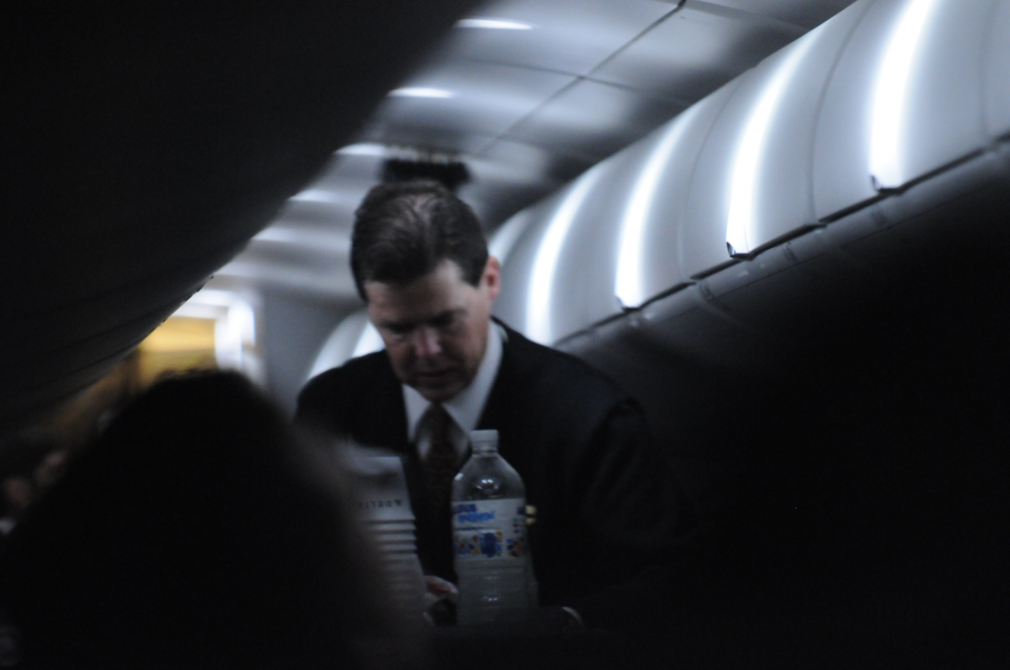 Steward bringing water on plane