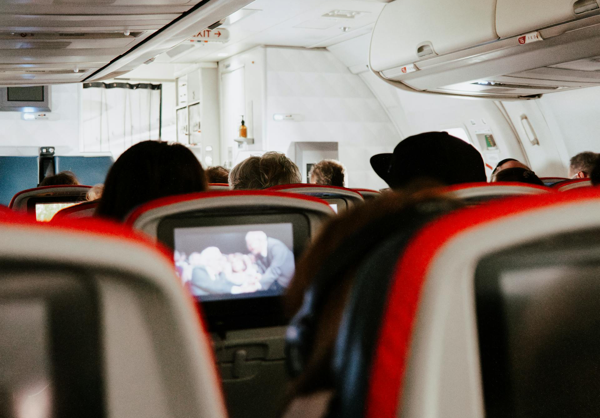 Airplane Cabin With People Sitting
