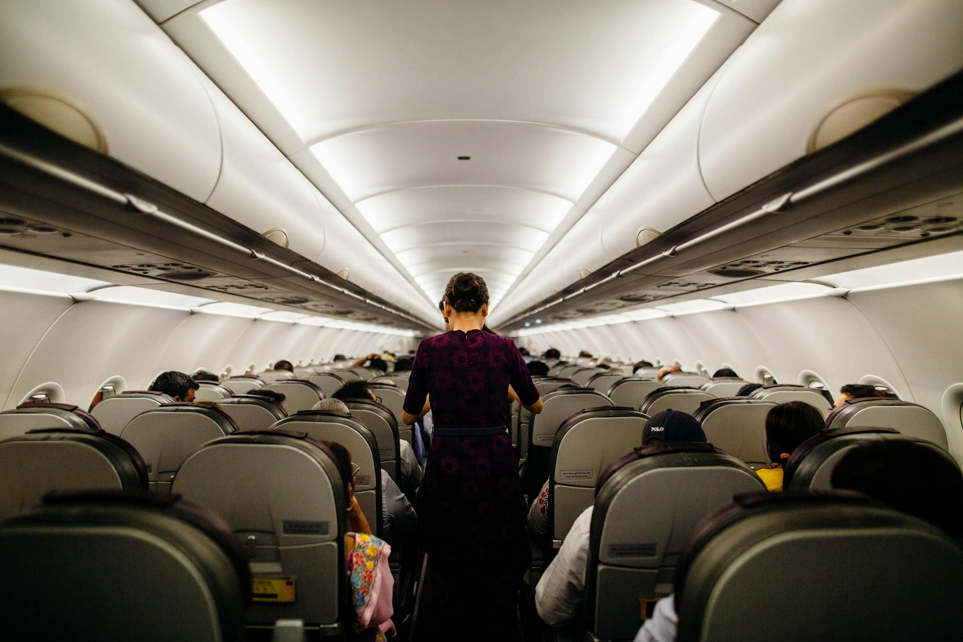 Flight Attendants standing at the Plane Aisle