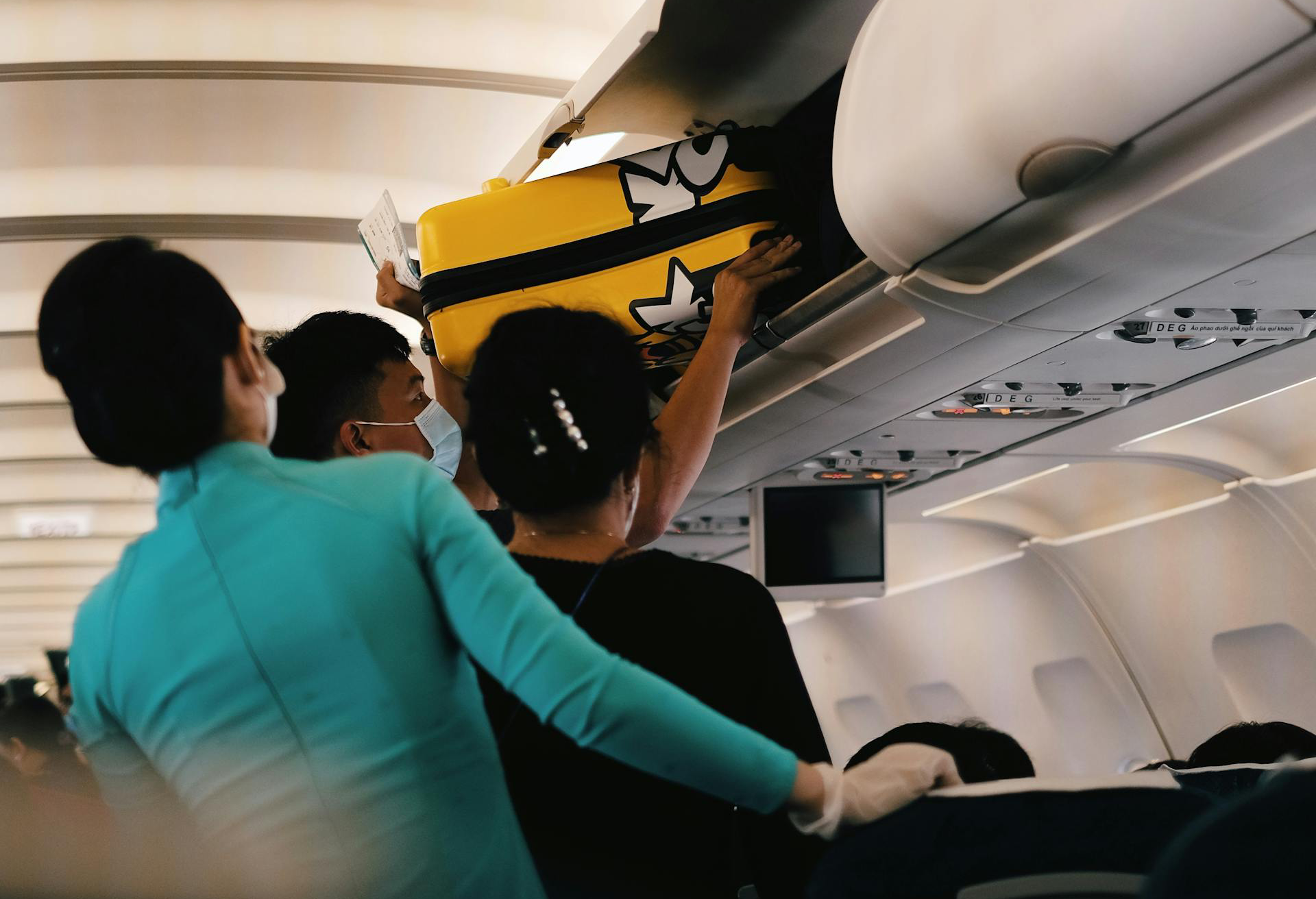 Passengers Storing Their Luggage Inside the Overhead Bin