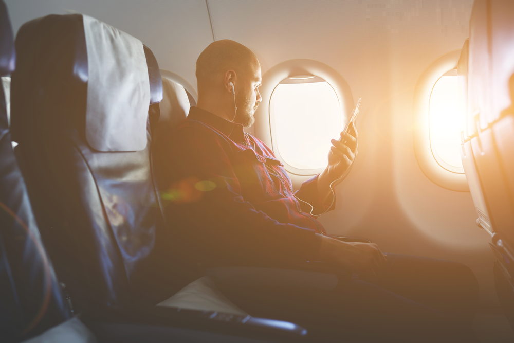 Young Guy Flying in A Plane Near A Window