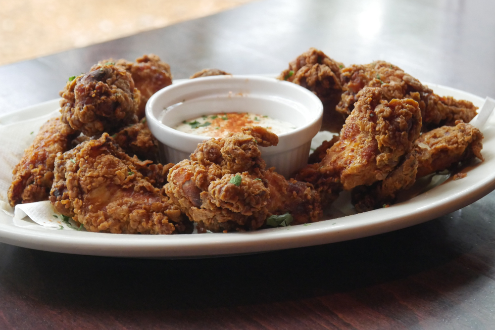 Golden fried chicken wings plated and served with creamy buttermilk ranch