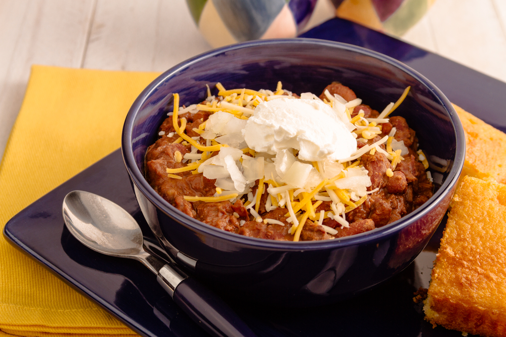 Elk meat chili with beans, sour cream, shredded cheese