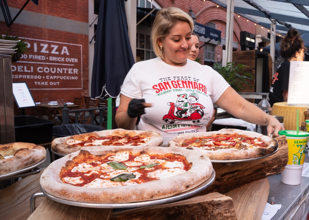 Pizza festival, woman in white t-shirt selling pizza