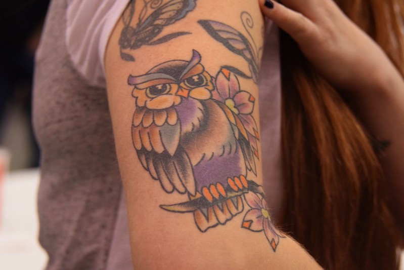 Photo of colorful Owl Tattoo on woman's Arm