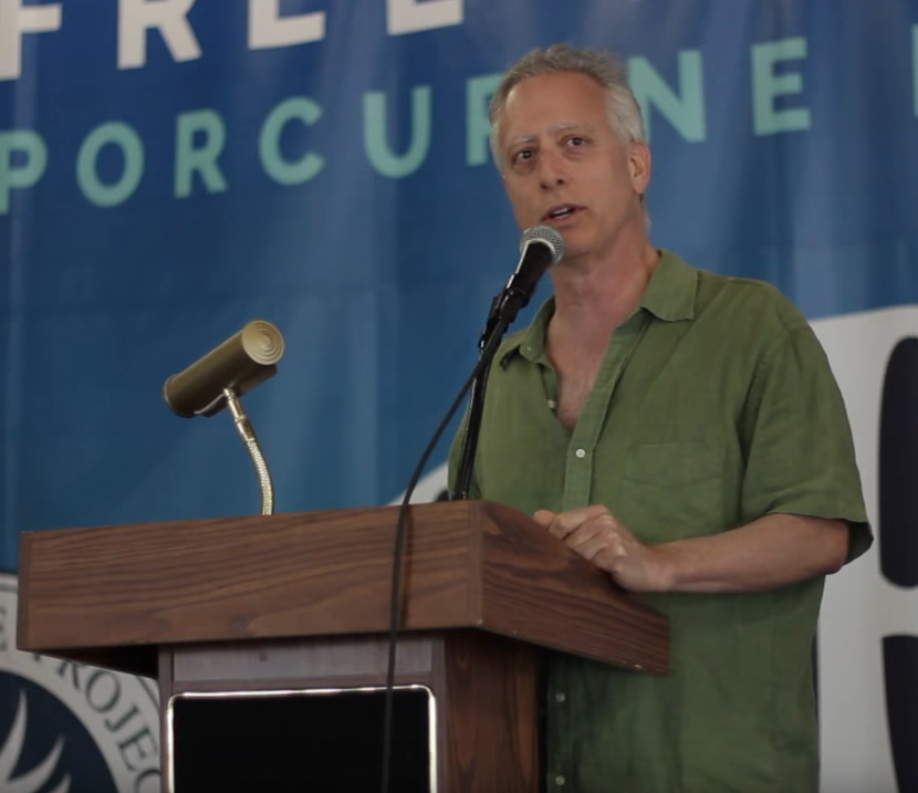 Russ Baker speaking at PorcFest in 2015.