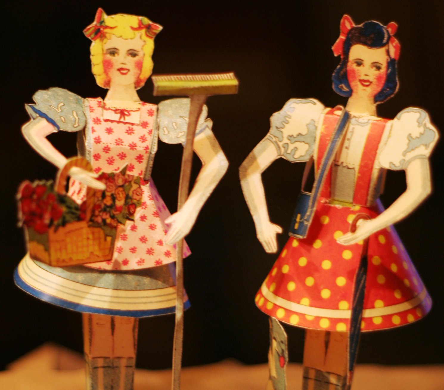 Close Up Photo of Vintage Paper Doll on Dark Background.