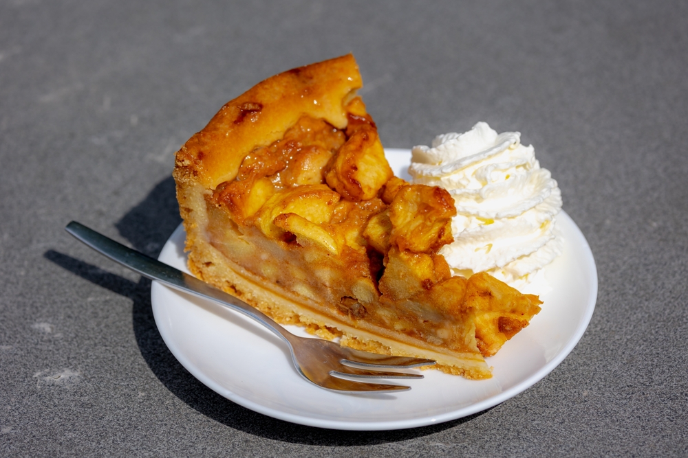 piece of homemade apple pie in white plate