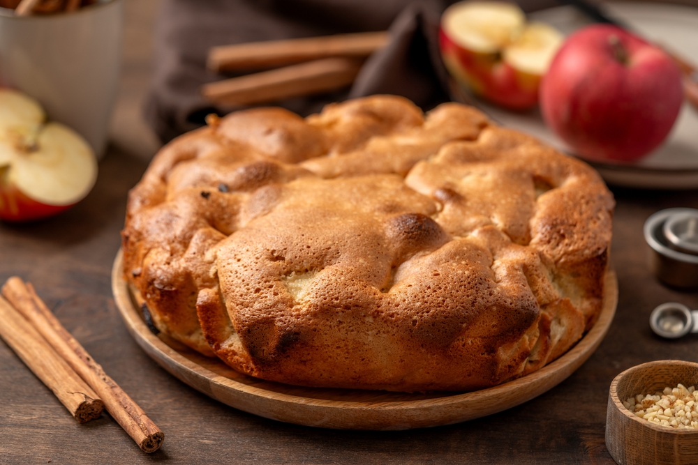 Traditional apple pie on a wooden plate