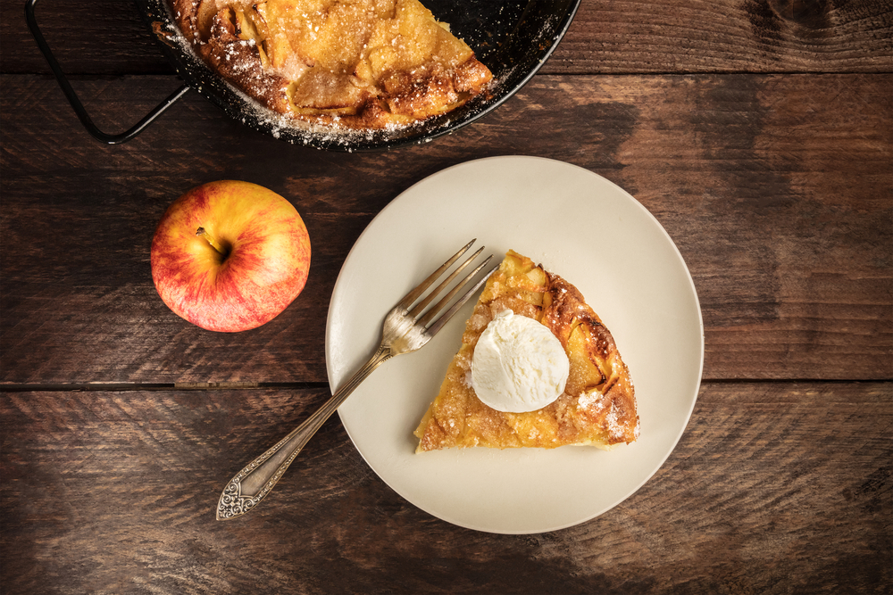 Apple pie and ice cream on wooden table