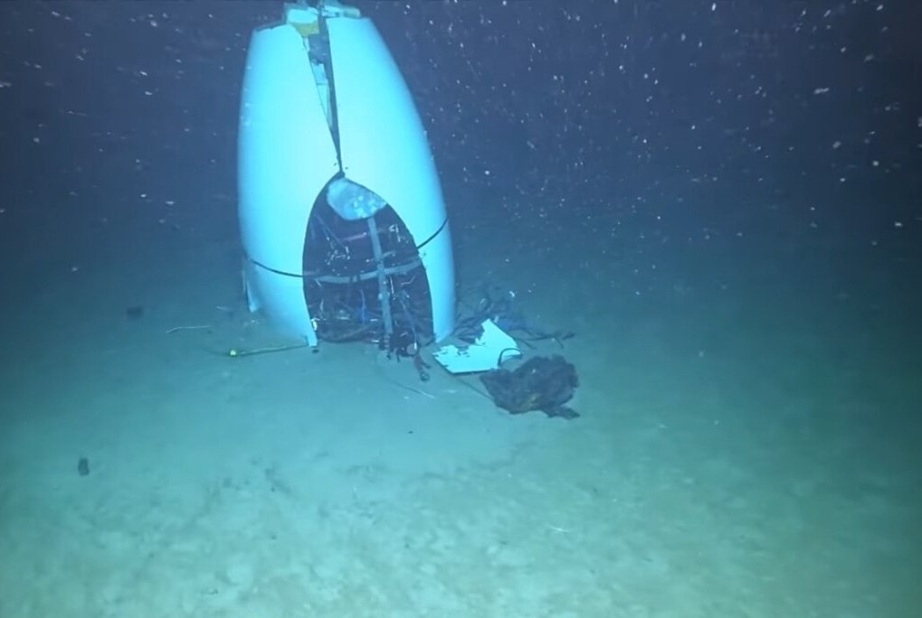 An image of TITAN submersible tail cone at the ocean floor