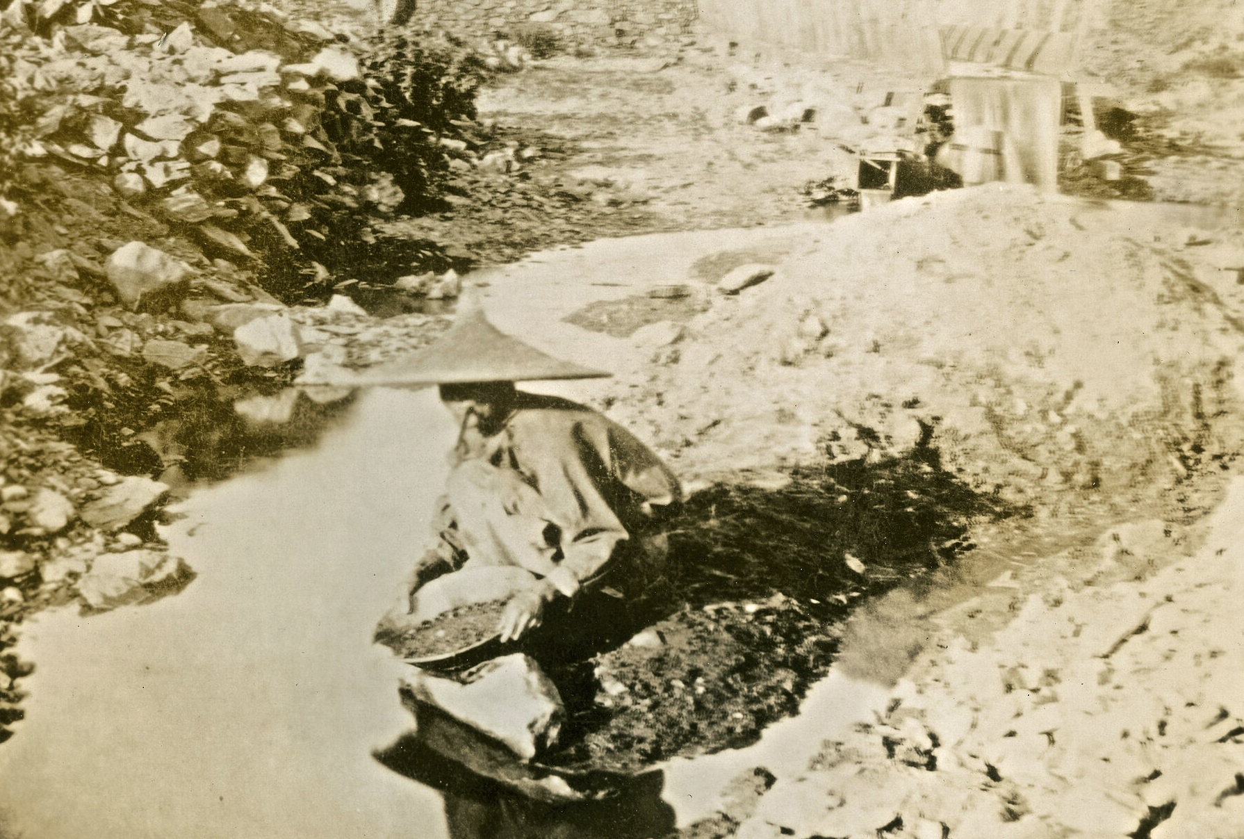 Chinese miner panning for gold in California in 1852