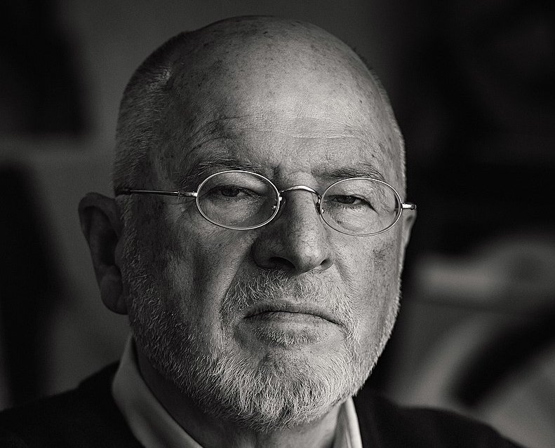 Grayscale Portrait Photo of Hans Ticha in dark outfit