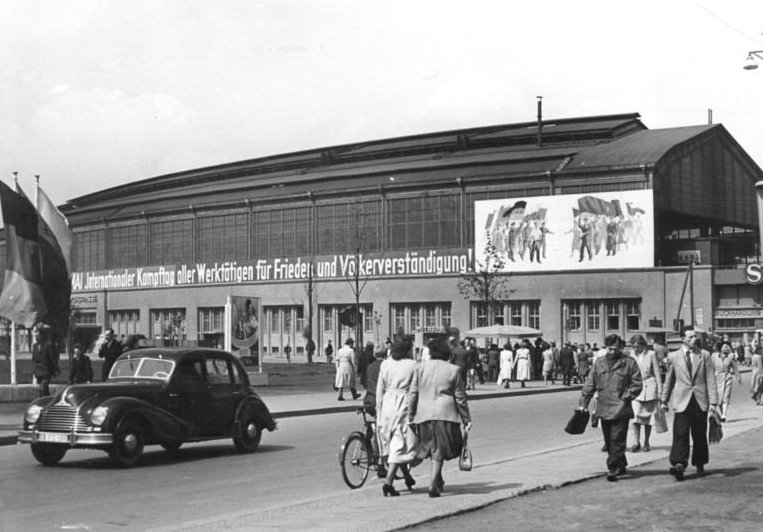 Grayscale Photo of Berlin decorated for May Celebration, Friedrichstraße Station