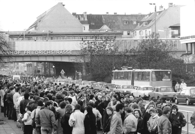 Grayscale Photo of GDR citizens at Friedrichstraße border crossing
