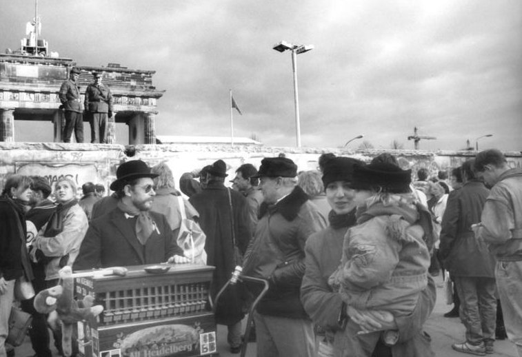 Numerous onlookers gathered around the Berlin Wall